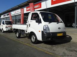 Kia Bongo truck at dealership storefront